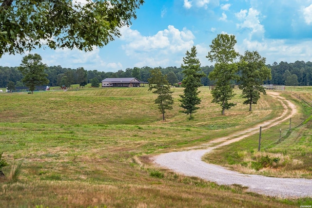 surrounding community featuring a rural view and gravel driveway