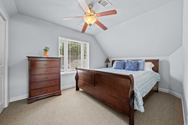 bedroom with lofted ceiling, visible vents, a textured ceiling, and baseboards