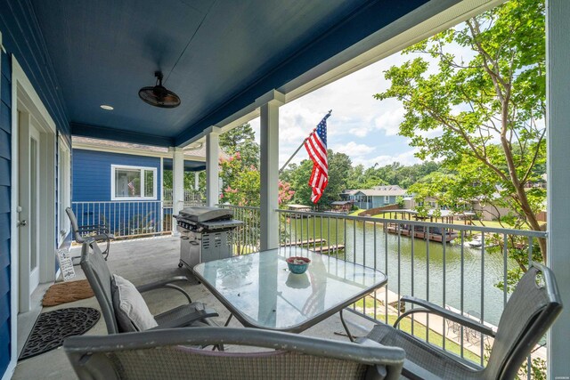 balcony featuring area for grilling and a water view