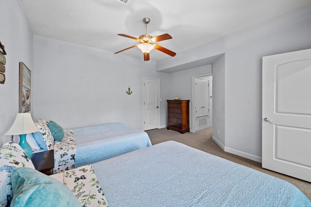 bedroom with light carpet, a ceiling fan, and baseboards