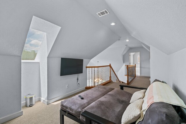 bedroom with recessed lighting, light colored carpet, vaulted ceiling, a textured ceiling, and baseboards