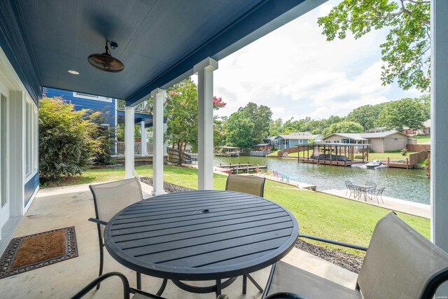 view of patio featuring outdoor dining area and a water view