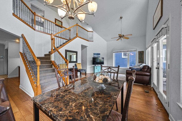 dining area featuring baseboards, a high ceiling, stairway, and dark wood finished floors