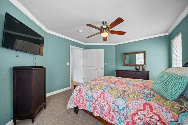 bedroom with ornamental molding, light colored carpet, ceiling fan, and baseboards