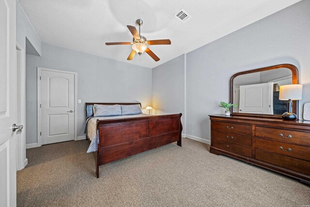 bedroom featuring light carpet, a ceiling fan, visible vents, and baseboards