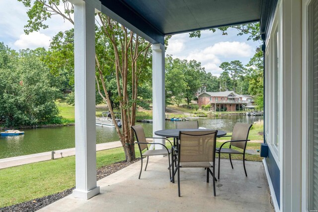 view of patio featuring outdoor dining area and a water view