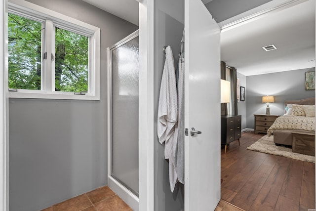 bathroom featuring a stall shower and ensuite bathroom