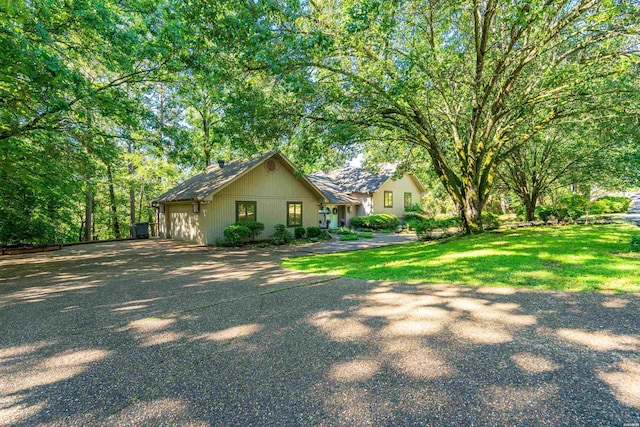 view of yard with driveway and a garage