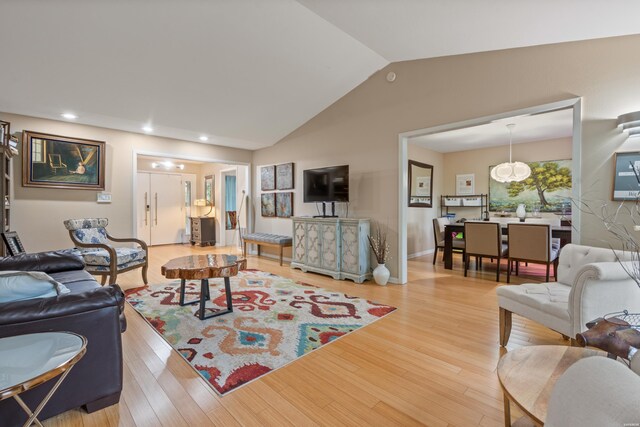 living room featuring vaulted ceiling, wood finished floors, and recessed lighting