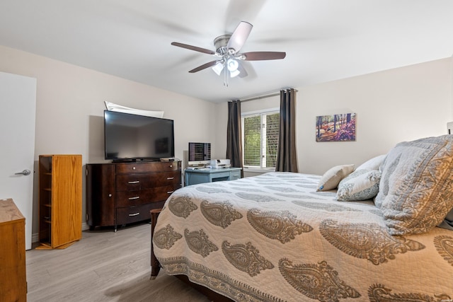 bedroom with light wood-style flooring and ceiling fan