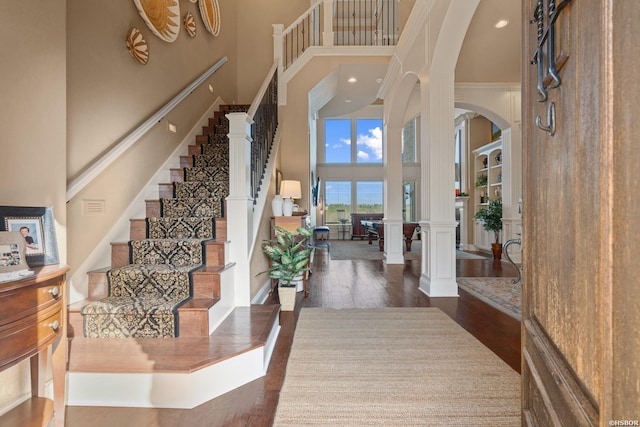 116 Lake Forest Shores Dr, Hot Springs, AR 71913 - entryway with stairs, a high ceiling, wood finished floors, arched walkways, and ornate columns
