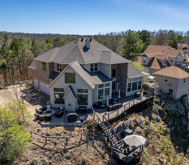 116 Lake Forest Shores Dr, Hot Springs, AR 71913 - back of property featuring a patio, a chimney, an outdoor fire pit, a garage, and a shingled roof