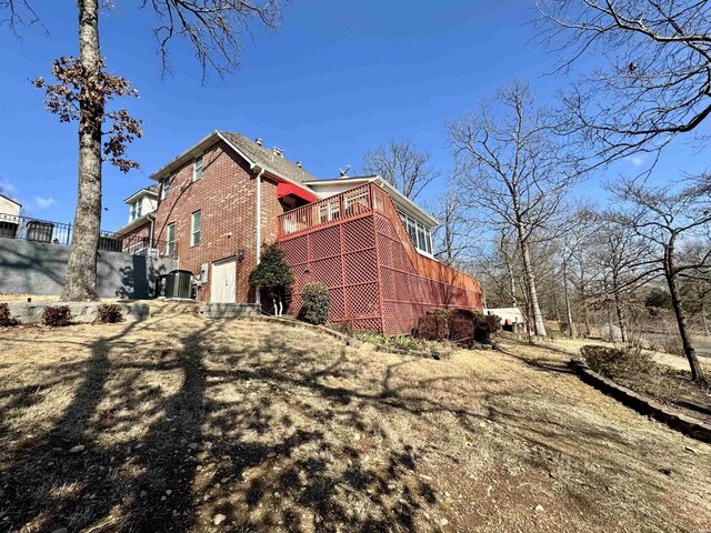 view of side of property featuring brick siding