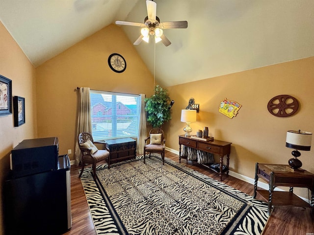 sitting room with ceiling fan, high vaulted ceiling, wood finished floors, and baseboards