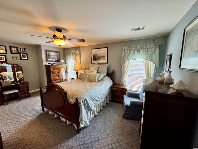 carpeted bedroom with ceiling fan, visible vents, and baseboards