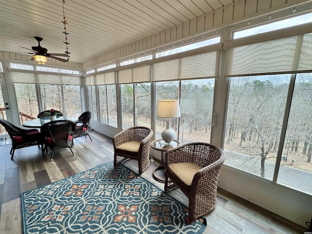 sunroom featuring a wealth of natural light and a ceiling fan