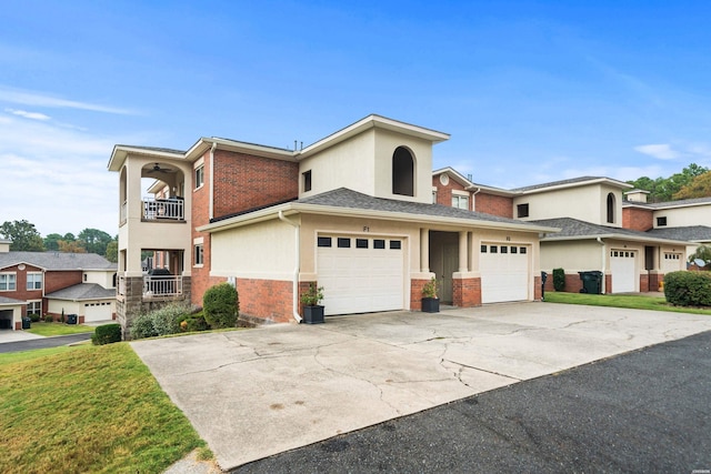 multi unit property with a balcony, stucco siding, driveway, and brick siding