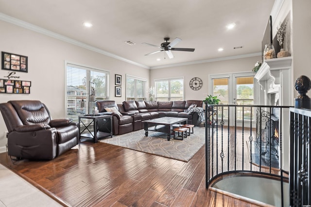 living area with ornamental molding, recessed lighting, visible vents, and wood finished floors