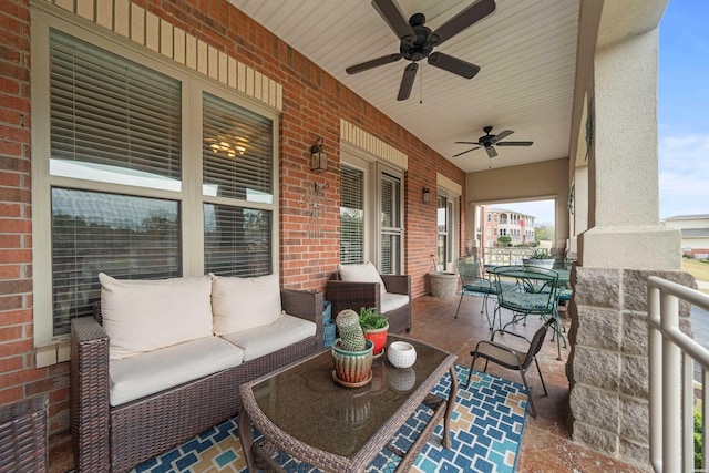 view of patio / terrace with outdoor dining area, an outdoor living space, a ceiling fan, and covered porch