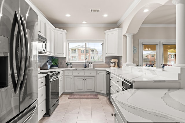 kitchen with a peninsula, refrigerator with ice dispenser, white cabinets, and stainless steel range with electric cooktop