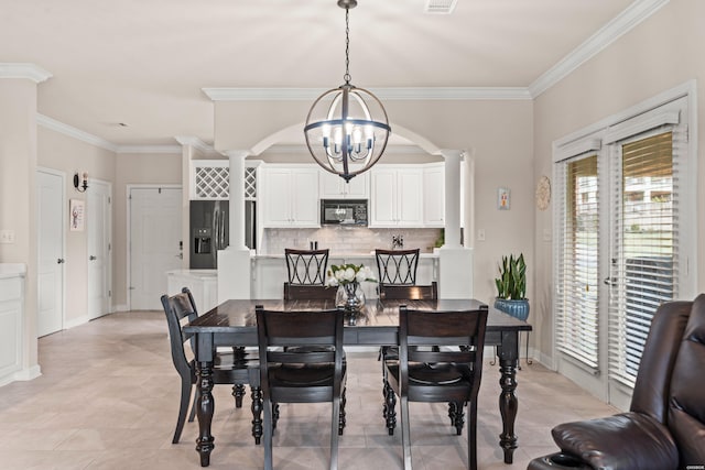 dining area with a notable chandelier, visible vents, baseboards, decorative columns, and crown molding