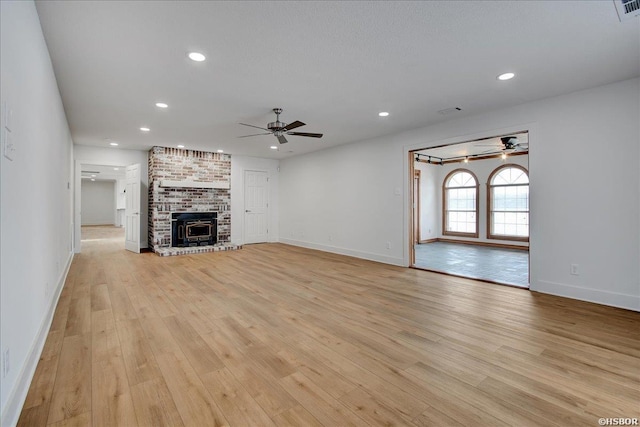 unfurnished living room featuring ceiling fan, light wood-style flooring, and recessed lighting