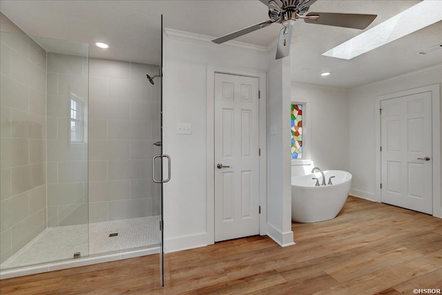 full bathroom featuring a soaking tub, visible vents, ornamental molding, a shower stall, and wood finished floors