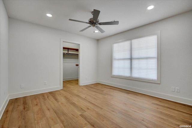 unfurnished bedroom featuring light wood finished floors, baseboards, and recessed lighting