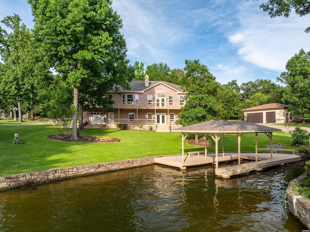 dock area with a water view and a yard