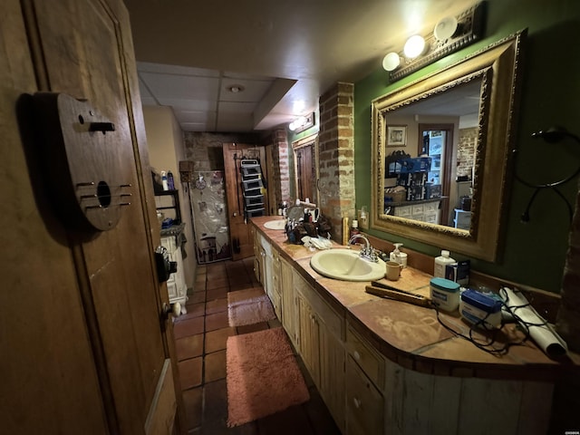 bathroom with double vanity, tile patterned flooring, and a sink