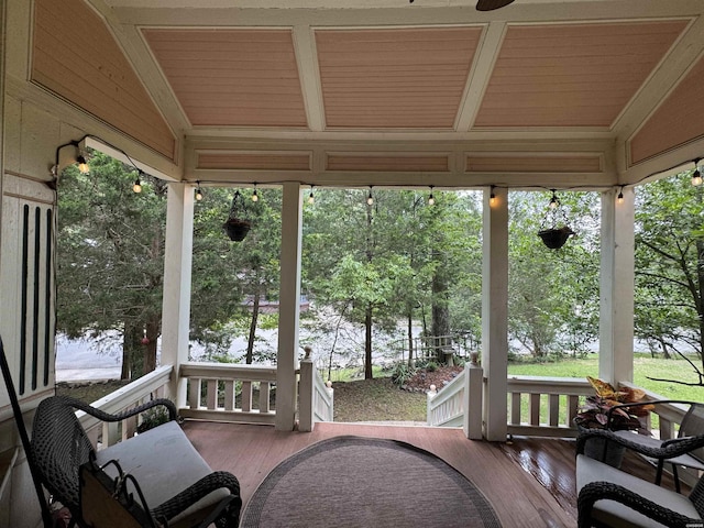 sunroom with lofted ceiling and plenty of natural light