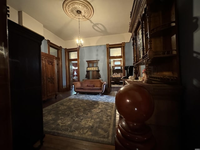 sitting room with a chandelier and wood finished floors