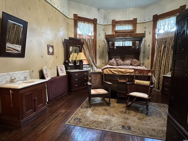 bedroom featuring dark wood-style floors and a sink