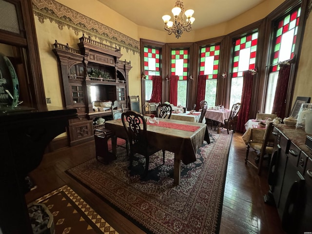 dining area featuring a chandelier and dark wood-style flooring