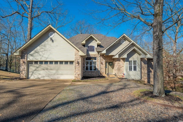 view of front facade with a garage, concrete driveway, brick siding, and a shingled roof