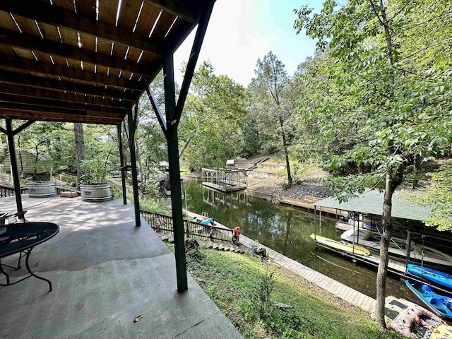 view of dock featuring a patio area and a water view