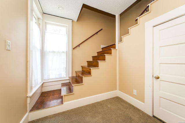 801 Crittenden St, Arkadelphia, AR 71923 - stairway with carpet flooring, a textured ceiling, and baseboards