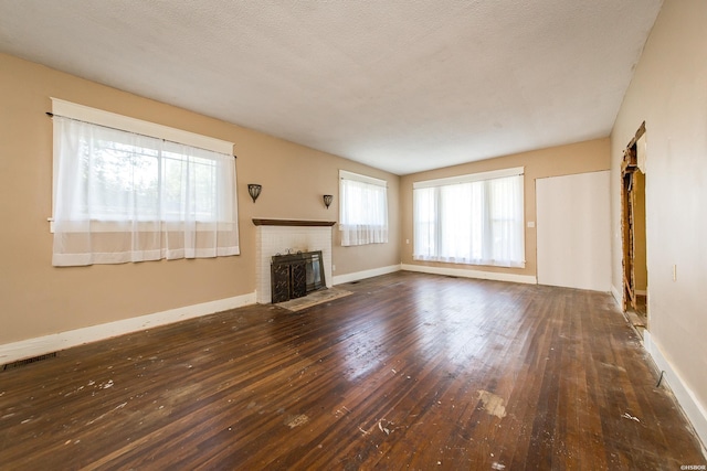 801 Crittenden St, Arkadelphia, AR 71923 - unfurnished living room featuring dark wood-type flooring, a fireplace, visible vents, and baseboards