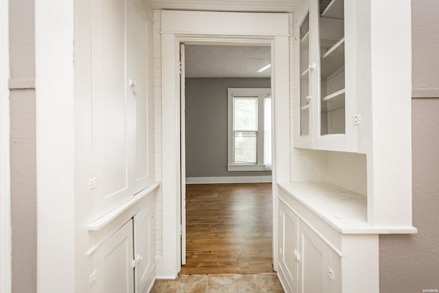 801 Crittenden St, Arkadelphia, AR 71923 - corridor with light wood-style floors and a textured ceiling