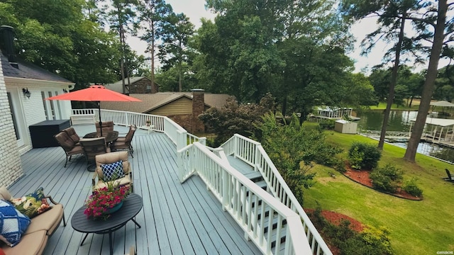 338 Sunset Bay Rd, Hot Springs, AR 71913 - wooden deck featuring outdoor dining area, a water view, view of wooded area, and a lawn