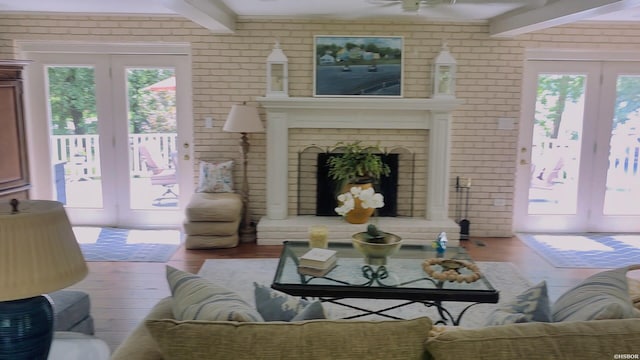 338 Sunset Bay Rd, Hot Springs, AR 71913 - living area with french doors, beamed ceiling, wood finished floors, healthy amount of natural light, and brick wall