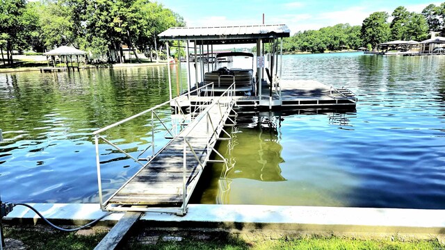 338 Sunset Bay Rd, Hot Springs, AR 71913 - wooden terrace featuring outdoor dining space, a water view, and view of scattered trees
