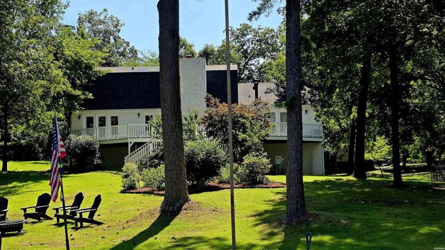 338 Sunset Bay Rd, Hot Springs, AR 71913 - view of front of home with stairway, a wooden deck, a front yard, and roof with shingles