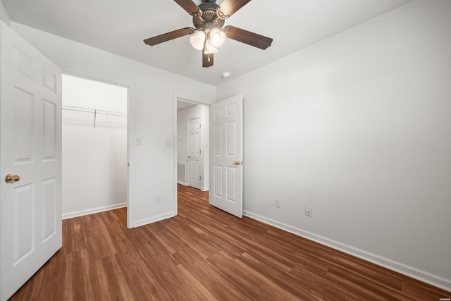 231 Garland Ave, Hot Springs, AR 71913 - unfurnished bedroom featuring wood finished floors, a ceiling fan, and a spacious closet
