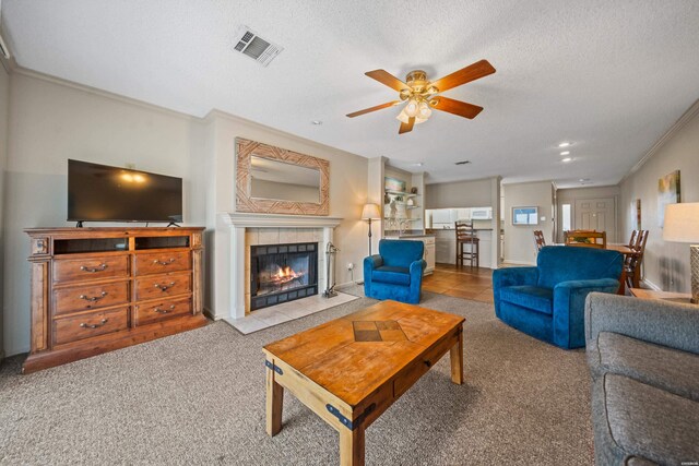 5371 Central Ave Unit 6J, Hot Springs, AR 71913 - carpeted living area with a tile fireplace, a ceiling fan, ornamental molding, a textured ceiling, and recessed lighting