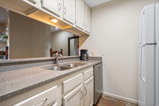 5371 Central Ave Unit 6J, Hot Springs, AR 71913 - kitchen with freestanding refrigerator, a sink, stainless steel dishwasher, baseboards, and white cabinetry