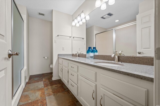 5371 Central Ave Unit 6J, Hot Springs, AR 71913 - bathroom with stone tile floors, a stall shower, double vanity, baseboards, and toilet
