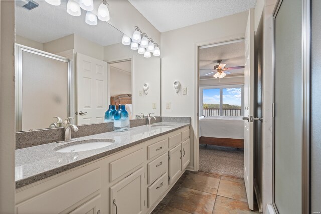 5371 Central Ave Unit 6J, Hot Springs, AR 71913 - ensuite bathroom with a textured ceiling, double vanity, a shower stall, tile patterned flooring, and a ceiling fan