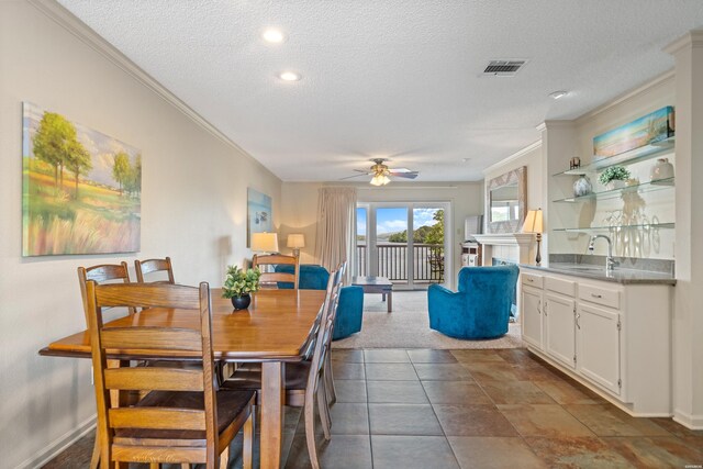 5371 Central Ave Unit 6J, Hot Springs, AR 71913 - dining area with ornamental molding, a textured ceiling, ceiling fan, baseboards, and a fireplace