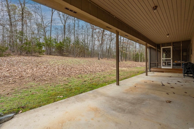 view of patio featuring a sunroom